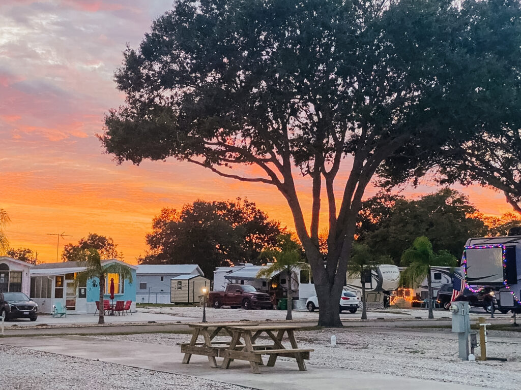 A beautiful sunset with Mobile Homes and picnic tables visible.